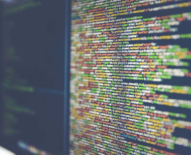 Code on a monitor representing technical attribution and tracking work