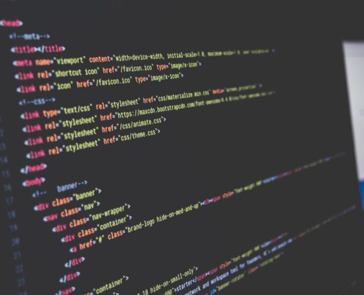 Website development workspace with code on a screen